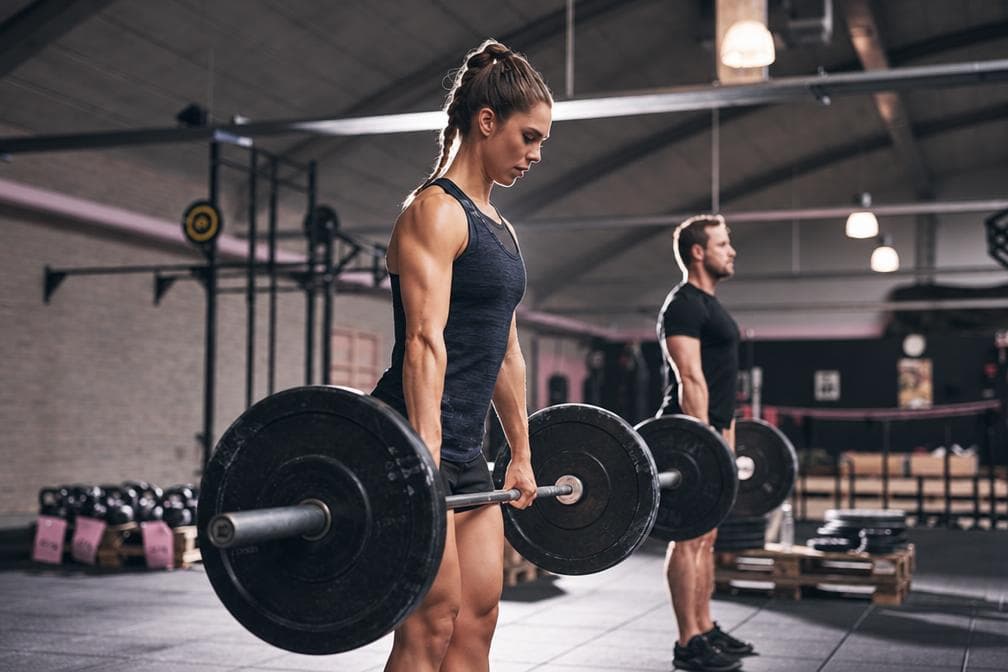 Editorial photo of a woman strength training; not a product photo.